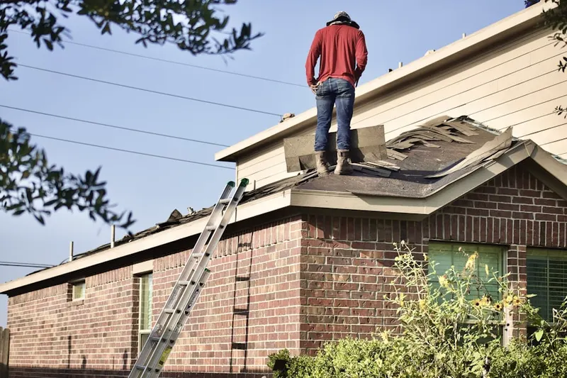 Professional roofer working on a residential roof in Vadnais Heights